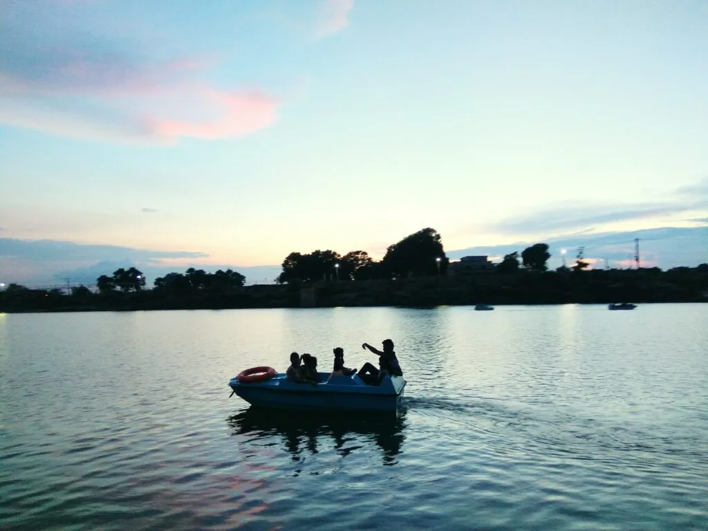 Top 10 Best Places to Visit in Meghalaya: A complete Guide 4 people boat lake against sky