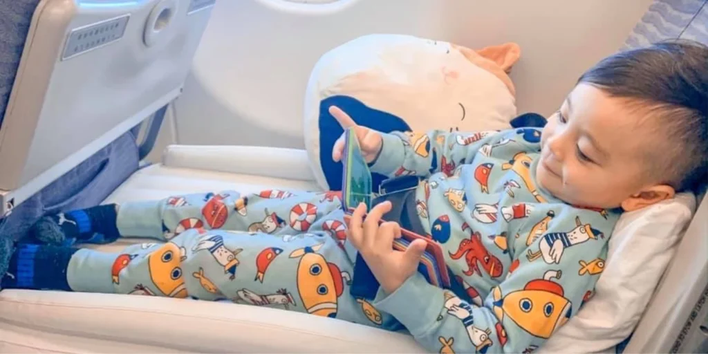How to Keep Kids Entertained During Long Flights 4 child on Flyaway Kids Bed 1